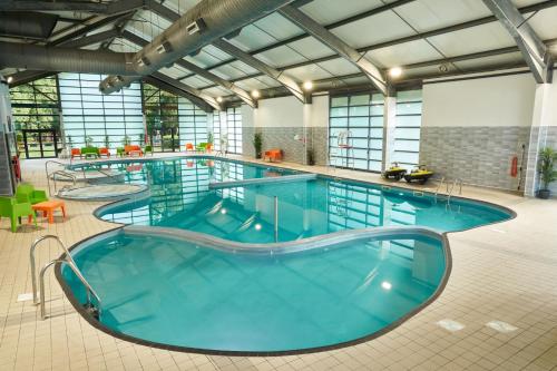 a large pool with blue water in a building at Whitemead Forest Park in Lydney
