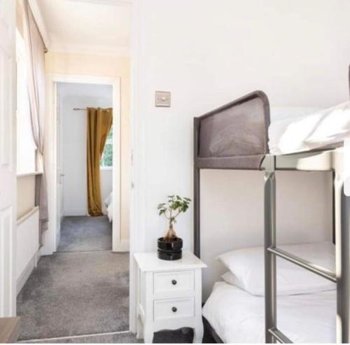 a dorm room with a bunk bed and a staircase at Beautiful Large Property, Sleeps 9 Walking Distance to the Sea , Beaches and Restaurants Fantastic Interior in Lyme Regis