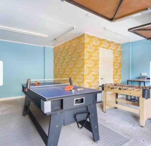 a room with a pool table and a ping pong table at Beautiful Large Property, Sleeps 9 Walking Distance to the Sea , Beaches and Restaurants Fantastic Interior in Lyme Regis