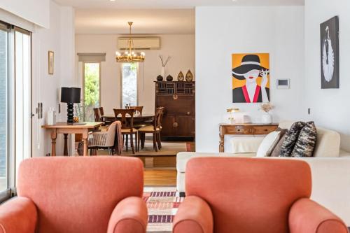 a living room with a couch and a dining room at THE OLD CHAPEL HOUSE in Funchal