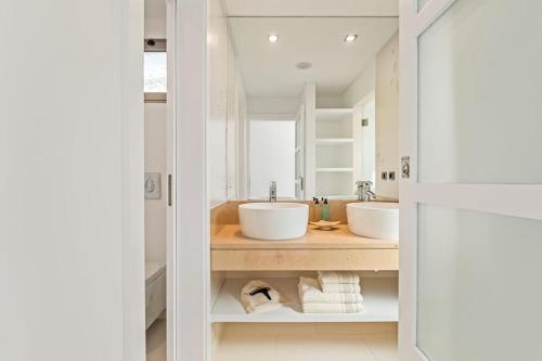 a bathroom with two sinks and a mirror at THE OLD CHAPEL HOUSE in Funchal