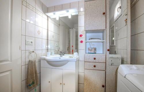 a white bathroom with a sink and a mirror at Amazing Home In Chassiers With House A Panoramic View in Chassiers