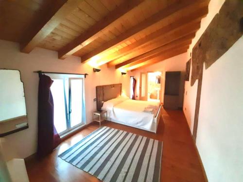 a bedroom with a bed and a large window at Atlante in Toscolano Maderno