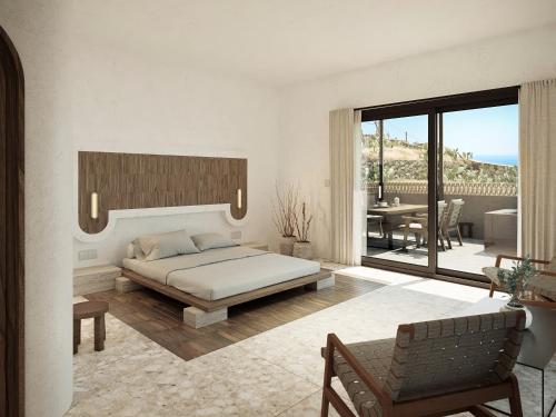 a bedroom with a large bed and a balcony at Sun Aeriko in Tinos