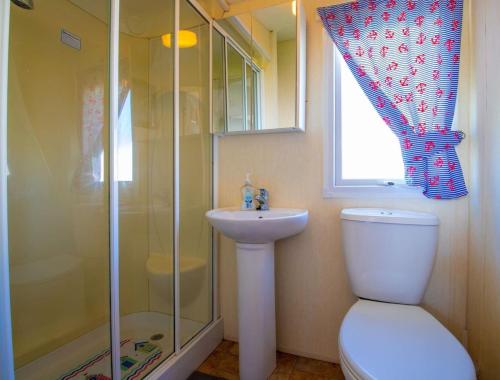 a bathroom with a shower and a toilet and a sink at WW213 - 4B - Parkdean Resorts - Camber Sands - Com in Camber