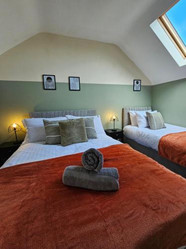 a bedroom with two beds with a red blanket at Charming 4-Bedroom House in Liverpool w/ WiFi - Sleeps 10 by PureStay in Liverpool