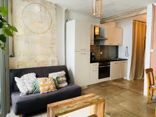 un salon avec un canapé et une cuisine dans l'établissement Centre historique Montpellier, à Montpellier