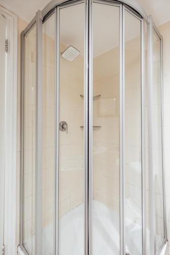 a shower with glass doors in a bathroom at Drieks' Place in Cape Town