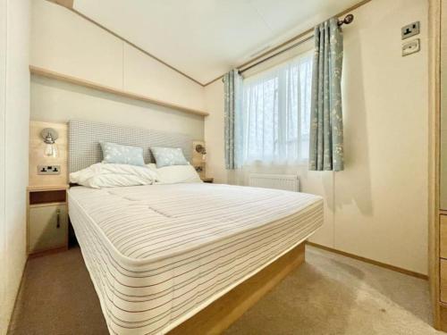 uma cama grande num quarto com uma janela em BW8 - 3B - ABI Windermere em Camber