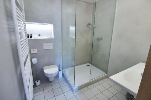 a bathroom with a shower and a toilet at Hotel 100 in Pardubice