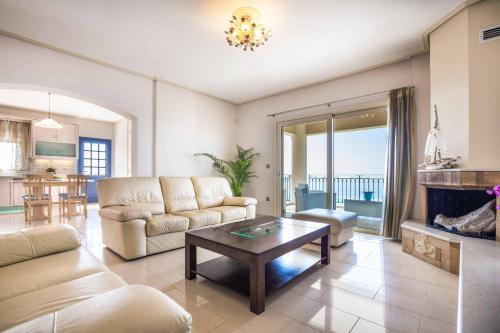 a living room with a couch and a coffee table at Villa Vlachata Emerald in Vlachata