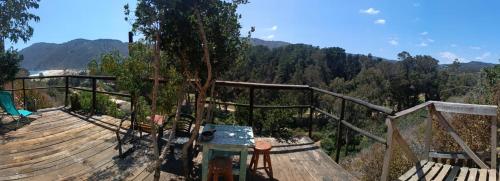 a wooden deck with a view of the mountains at Cabaña con Vista al mar Playa grande Quintay in Casablanca