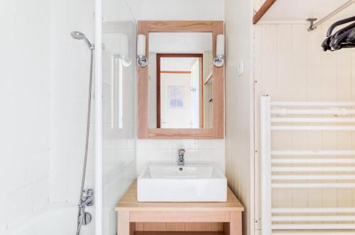 une salle de bain avec un lavabo et un miroir dans l'établissement Résidence Port du Crouesty - maeva Home - Appartement 2 Pièces 4 Personnes - Confort MAE-6454, à Arzon
