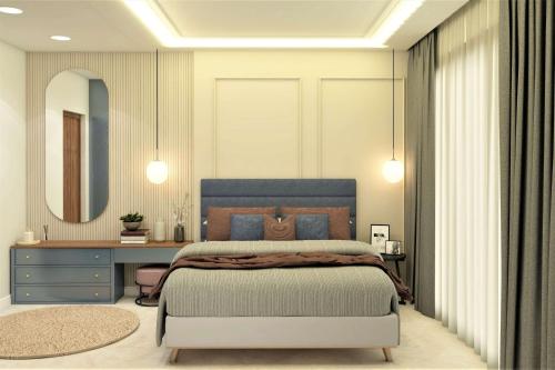 a bedroom with a bed and a desk and a mirror at City Plaza in Panchkula