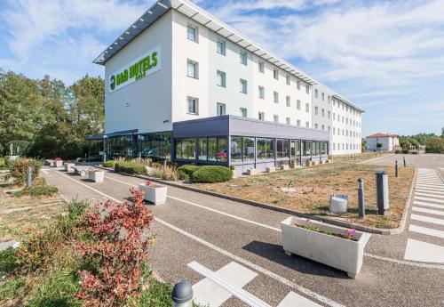 a large white building with a hotel at B&B HOTEL Colmar Liberté 4 étoiles in Colmar