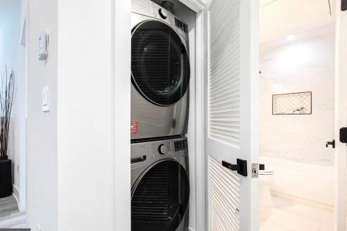 two washer and dryer stacked in a closet at Amazing Capital Hill APT , Step away Gym, shopping in Washington, D.C.
