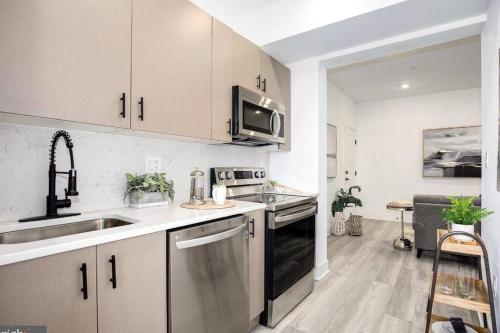 a kitchen with a sink and a stove top oven at Amazing Capital Hill APT , Step away Gym, shopping in Washington, D.C.