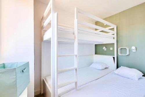 Cette chambre dispose de lits superposés avec 2 lits et une échelle. dans l'établissement Résidence le Village de Cap Esterel - maeva Home - Appartement moderne 2 pièces 5 personnes - Prestige - super Home MAE-6974, à Saint-Raphaël