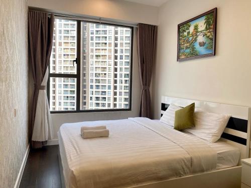 a bedroom with a large bed with a large window at Spacious Apartment with 3-bedroom in District 7 in Ho Chi Minh City