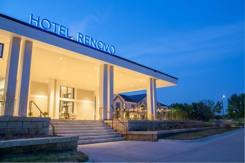 a hotel with a sign on the front of a building at Hotel Renovo Des Moines Urbandale,Tapestry Collection Hilton in Urbandale