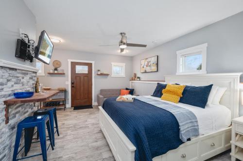 a bedroom with a bed with blue and yellow pillows at Studio TC Close to Downtown Beaches and Wineries in Traverse City