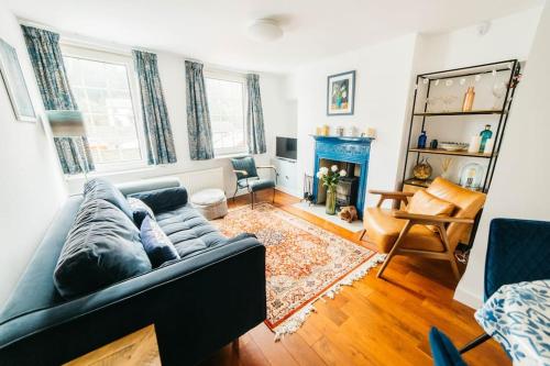 a living room with a couch and a fireplace at Charming & Stylish 2-Bed House - 20 min Walk to Centre in Bath