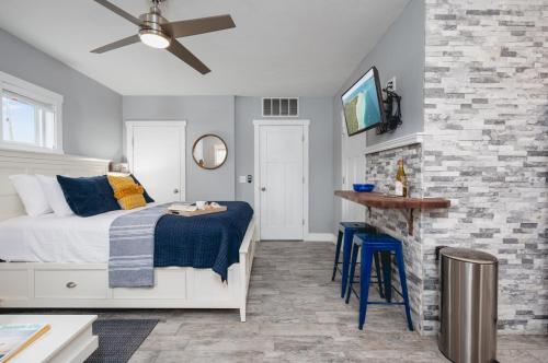 a bedroom with a bed and a stone wall at Studio TC Close to Downtown Beaches and Wineries in Traverse City