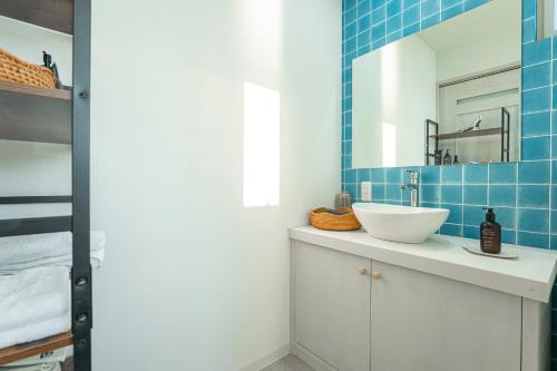 a bathroom with a sink and a mirror at HOMIE TERRACE Funakata in Tateyama