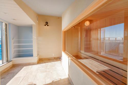 a room with a balcony with a large window at HOMIE TERRACE Funakata in Tateyama