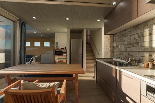 a kitchen and dining room with a table and a sink at HOMIE TERRACE Funakata in Tateyama