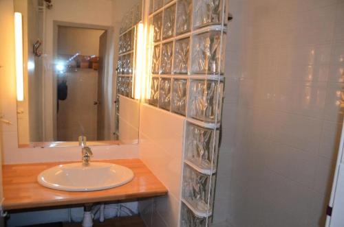 a bathroom with a sink and a mirror at Résidence Lac Du Lou - 2 Pièces pour 4 Personnes 224 in Les Menuires