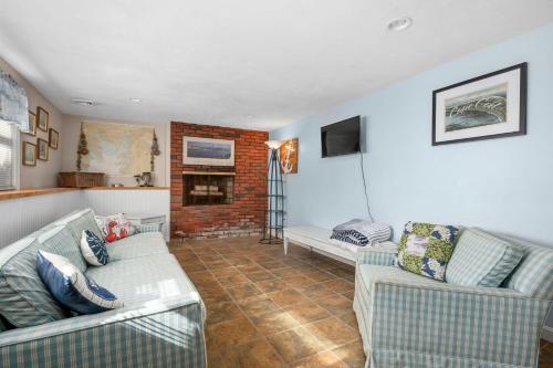 a living room with two couches and a fireplace at 51 Carman Avenue Sandwich - Cape Cod in Sandwich