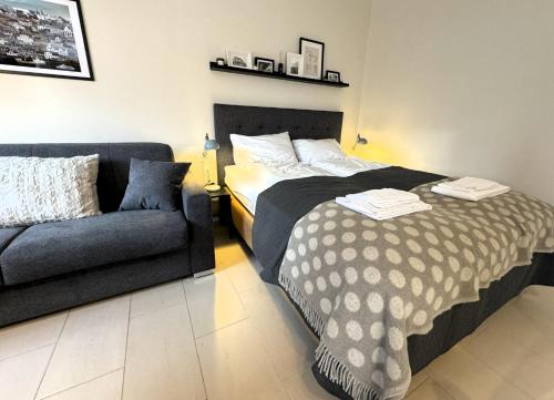 a bedroom with a bed and a couch at Day Dream Mjostraeti 10a in Reykjavík