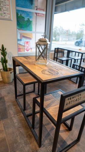 a wooden table with a lamp on top of it at Hôtel Des Docks in Digoin