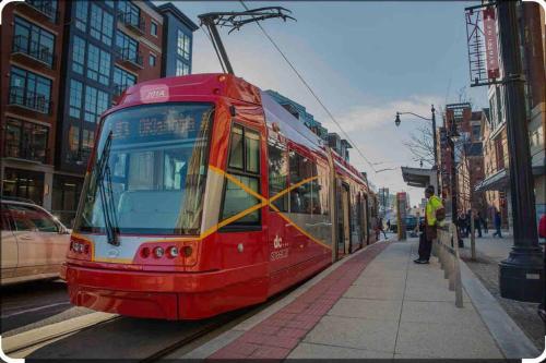 a red tram on a street in a city at BrandNew Luxury Capitol Hill APT! Near Free Trolly in Washington, D.C.