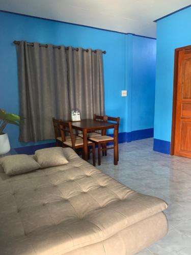 a bedroom with a bed and a table with chairs at Blue Sky Home stay 