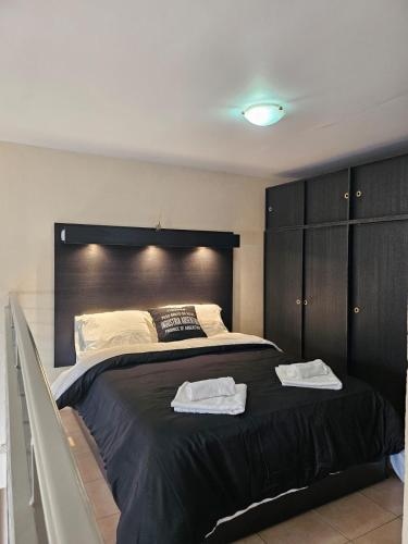 a bedroom with a large bed with two towels on it at Monoambiente en Duplex Velez Sarsfield in Buenos Aires