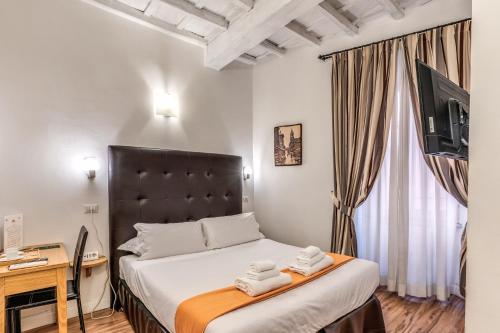 a bedroom with a bed with two towels on it at Magenta Collection Cancello in Rome