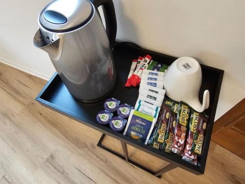 a table with a tea pot and magazines on it at Die Alte Apotheke _ Apartment Nr.2 in Baiersbronn
