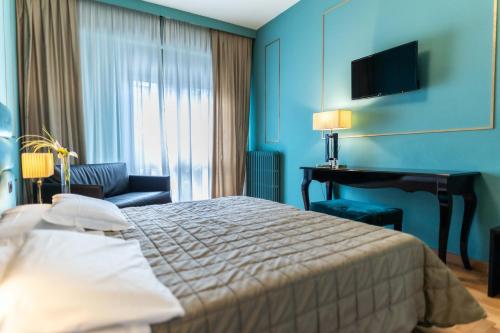 a hotel room with a bed and a piano at Hotel Terme Milano in Abano Terme
