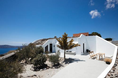a white house with a view of the water at Santorini Princess Spa Hotel in Imerovigli