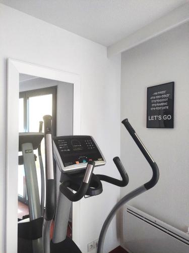 a treadmill in a room with a mirror at Avignon Grand Hotel in Avignon