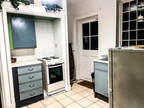 a kitchen with a stove top oven in a kitchen at Spacious House with 4 parking spaces in Canterbury