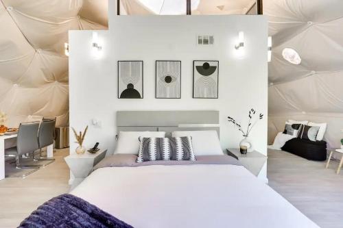 a bedroom with a large white bed and a desk at Unique Escapes - Modern Luxury Geodome in Monticello