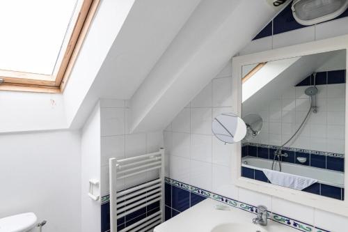 une salle de bain avec un lavabo et un miroir dans l'établissement Port du Crouesty Cap'Océan - maeva Home - Appartement 3 pièces 7 personnes - Sélection - vue sur le Port MAE-0824, à Arzon