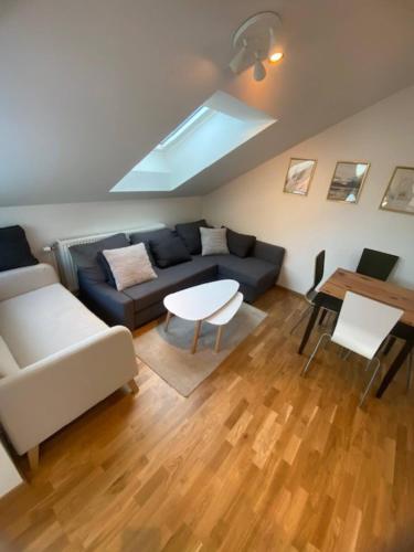 a living room with a couch and a table at Cozy Apartment Close To Central Station in Gothenburg