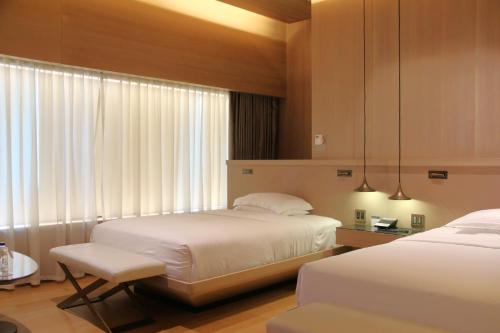 a hotel room with two beds and a window at Hyatt Centric Levent Istanbul in Istanbul