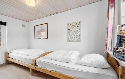 two beds in a room with white walls at Pet Friendly Home In Nrre Nebel With Wifi in Nymindegab