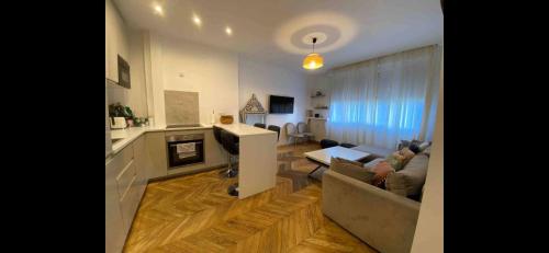 een woonkamer en een keuken met een bank en een tafel bij Nice stay in city center with Parking in Boulogne-Billancourt