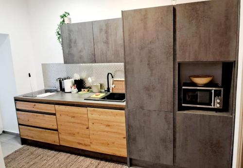 a kitchen with a sink and a microwave at A&Z APARTMENT in Zagreb